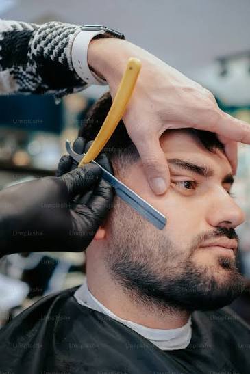 Beard being trimmed and shaped by a barber