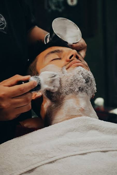 Clean shave and facial treatment for a male client